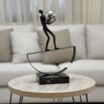 Balancing Man with Steel Sphere Sculpture